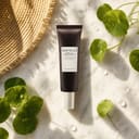 Skin1004 Probio-Cica Glow Sun Ampoule on surface with sun and botanical elements